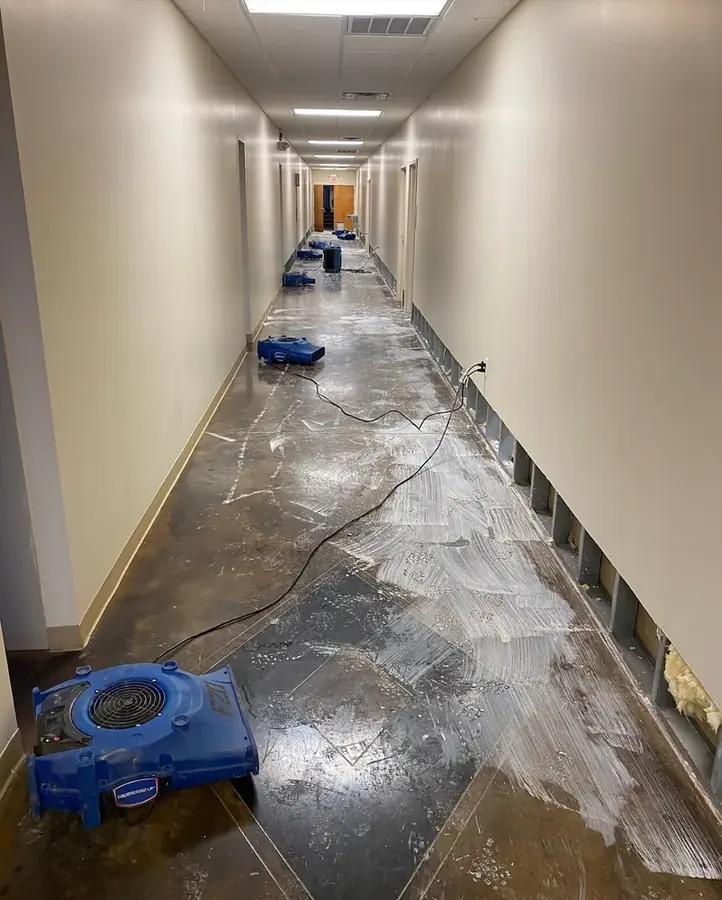 Air movers running down a flooded hallway