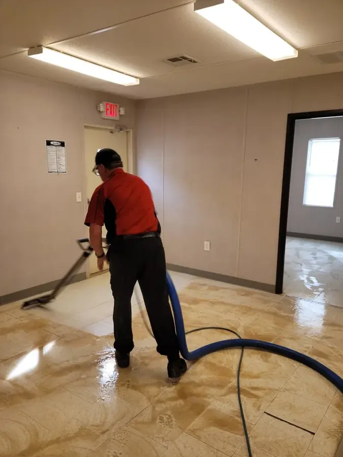 Restoration technician extracting water from a flooded High Point, NC home