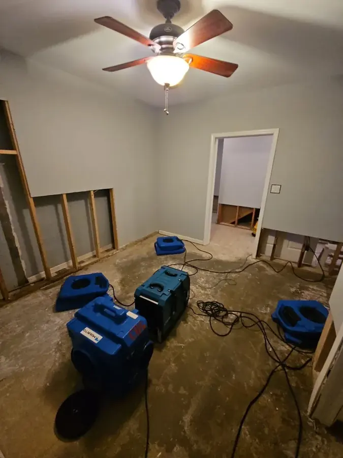 Air movers and dehumidifiers drying a High Point, NC room