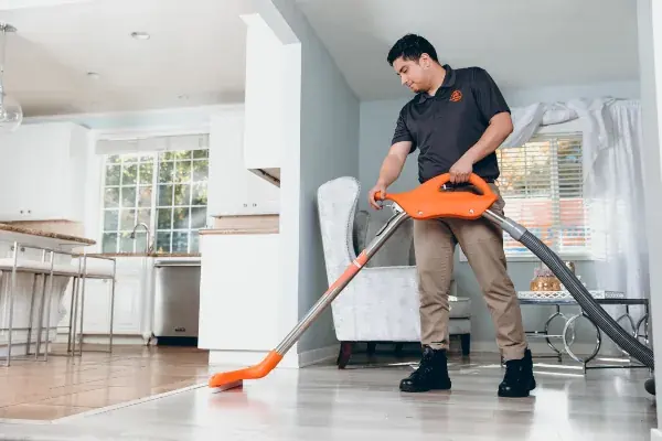 Technician extracting standing water from a High Point, NC floor
